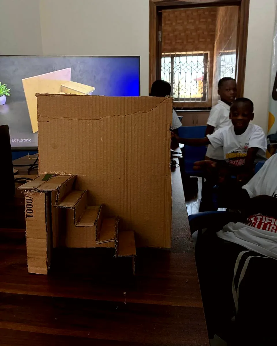 A cardboard staircase model on a desk in the classroom